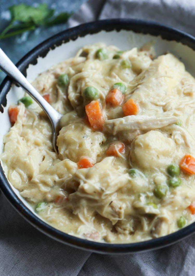 A bowl of slow cooker chicken and dumplings with shredded chicken