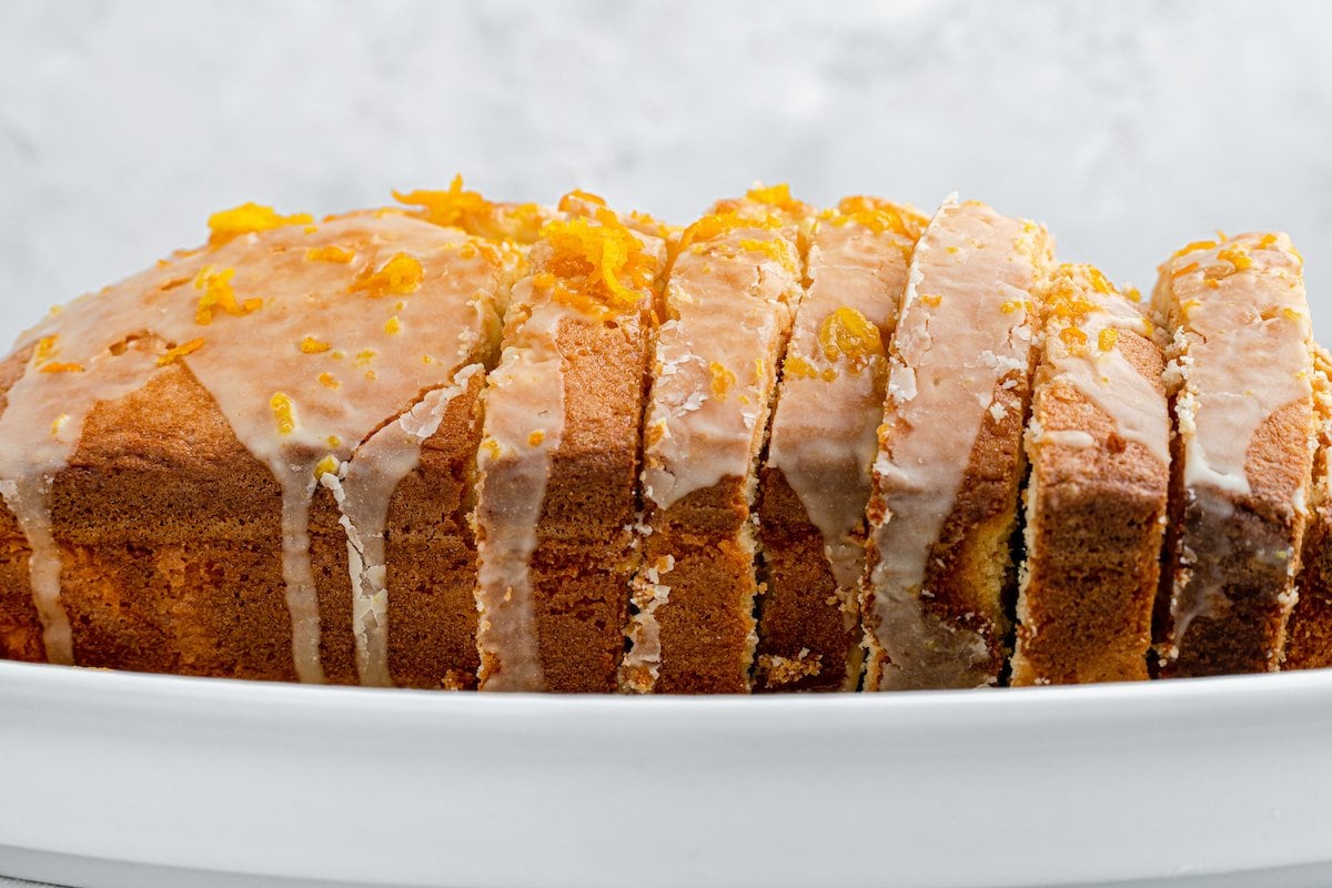 A loaf of orange pound cake with orange glaze.