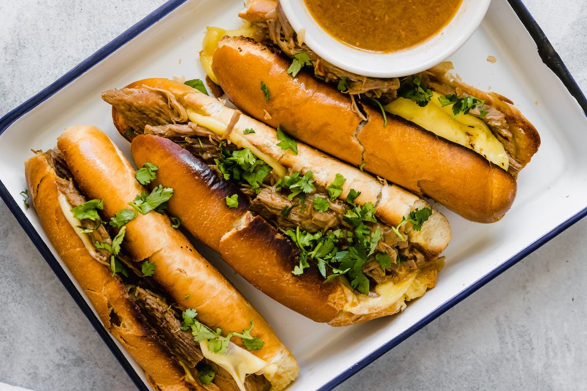 Three slow cooker French dip sandwiches.