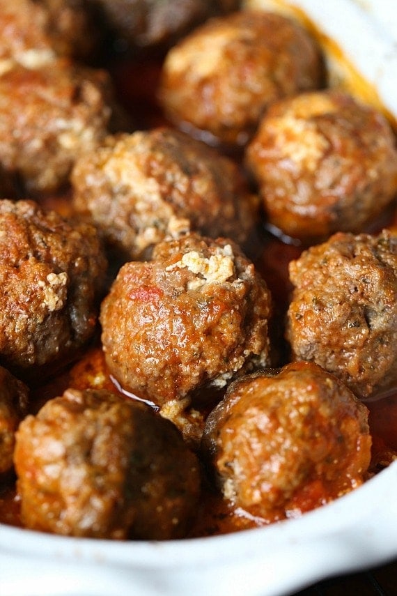 Cooked ricotta stuffed meatballs inside the slow cooker.