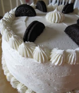 A Chocolate Cake with Vanilla Buttercream Frosting and Oreo Cookies on Top